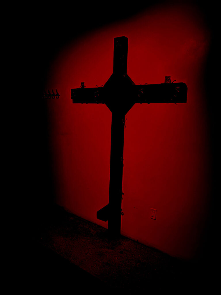 cross in the wall with red light