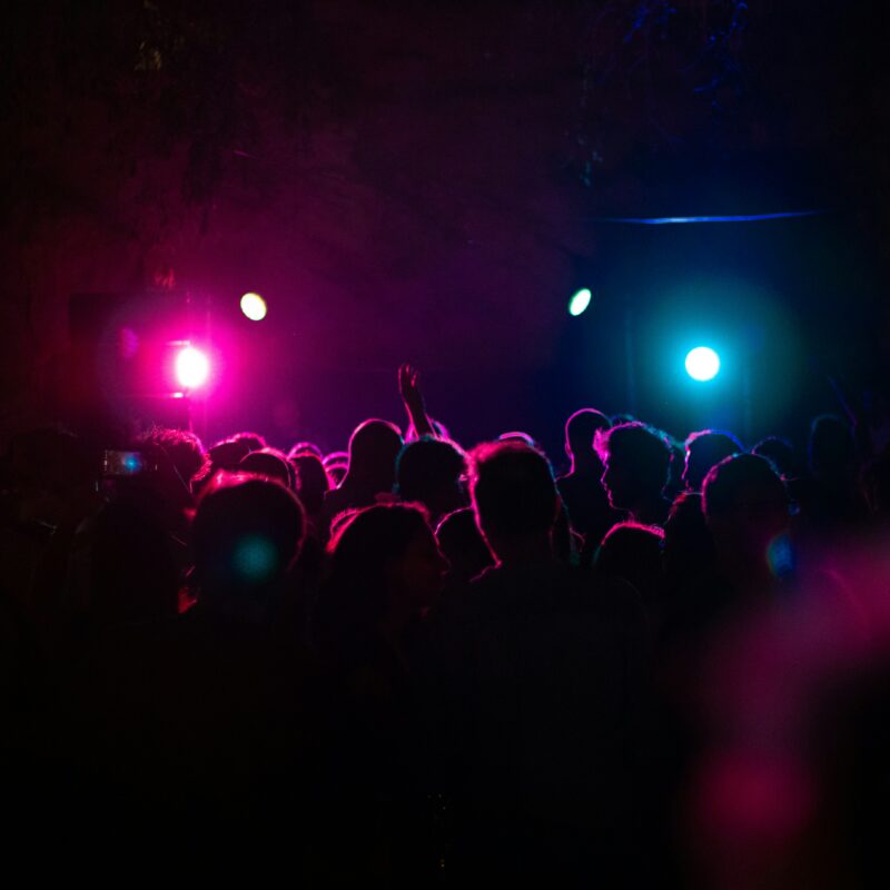 People standing in the dark with lights
