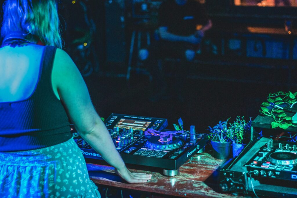 DJ woman standing in her music equipment