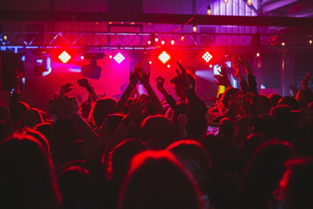 People standing on stage with lights turned on during nighttime