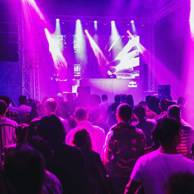 a crowd of people standing around a stage