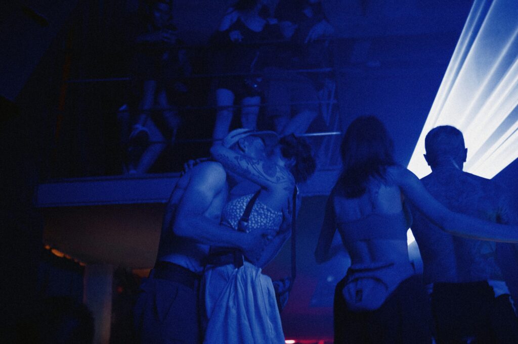 People are dancing in a blue light