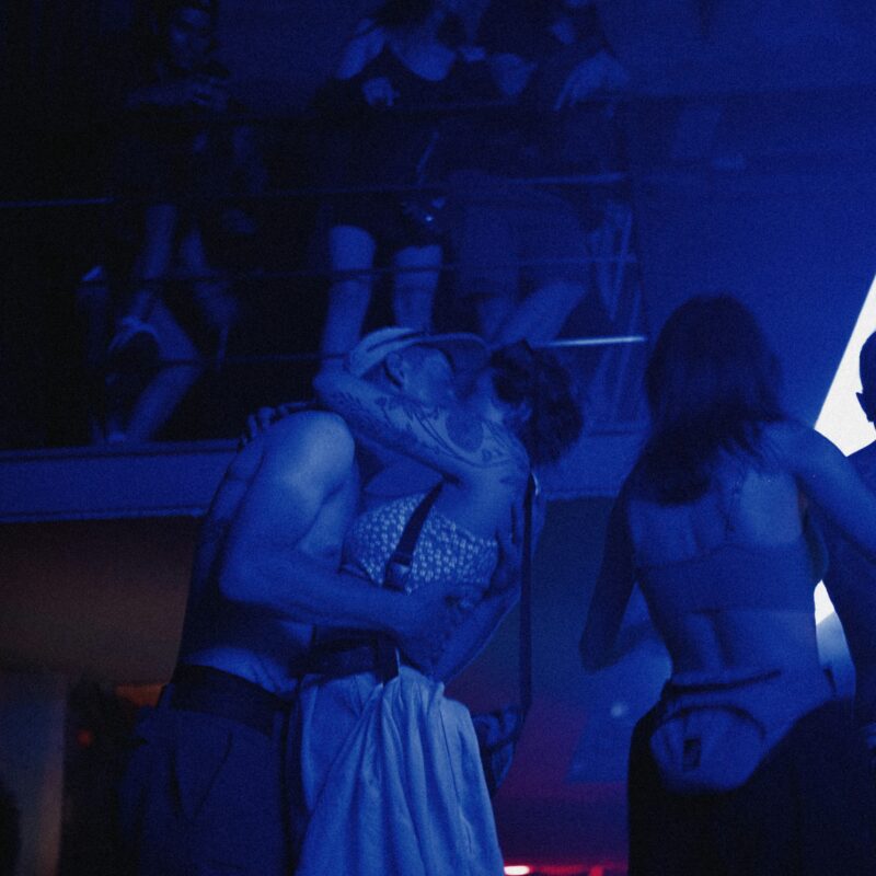 People are dancing in a blue light