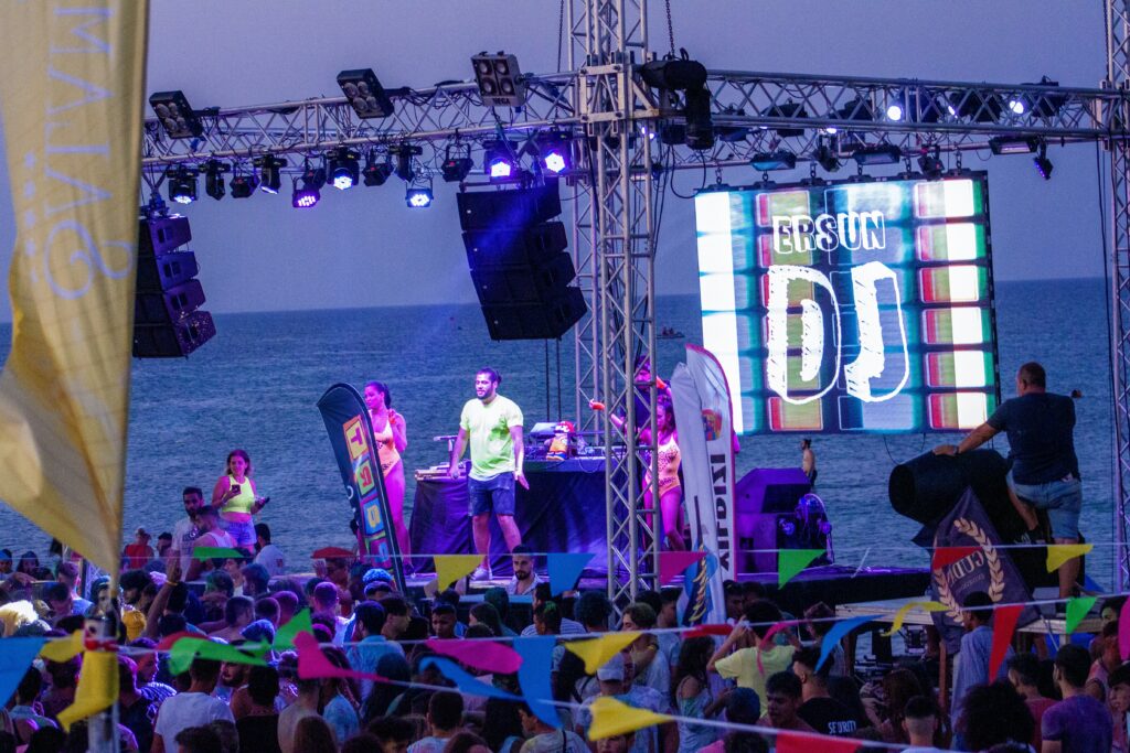 a group of people on a stage with a crowd watching