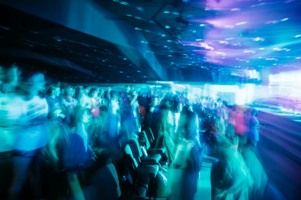 a large group of people standing in a room