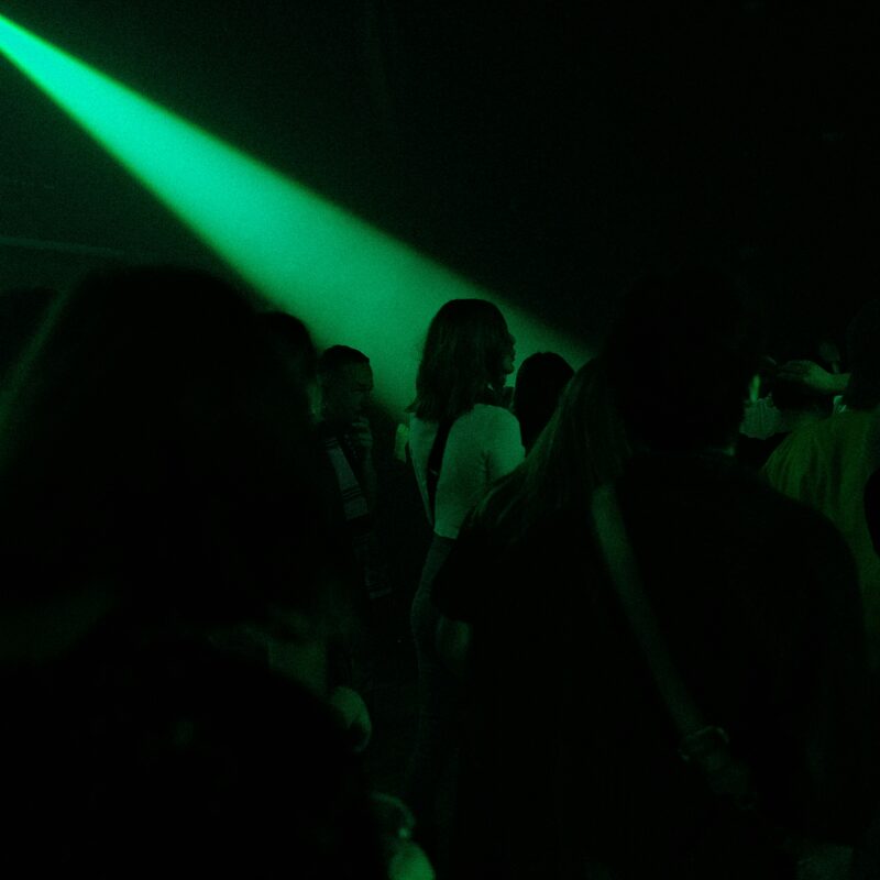 People in the crowd with green lights