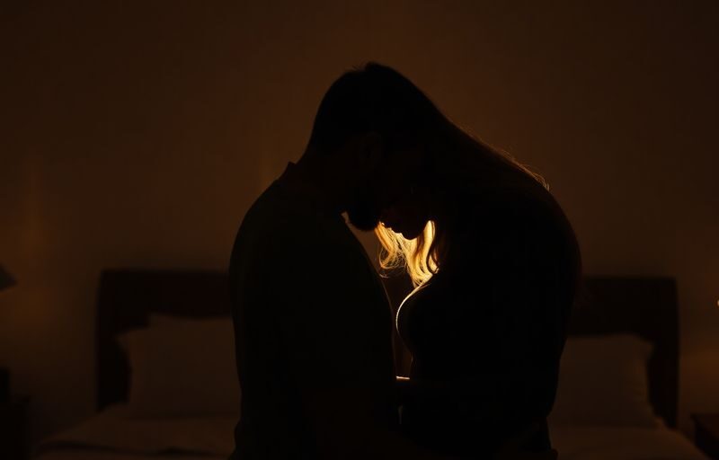 Couple in intimate embrace, soft lighting