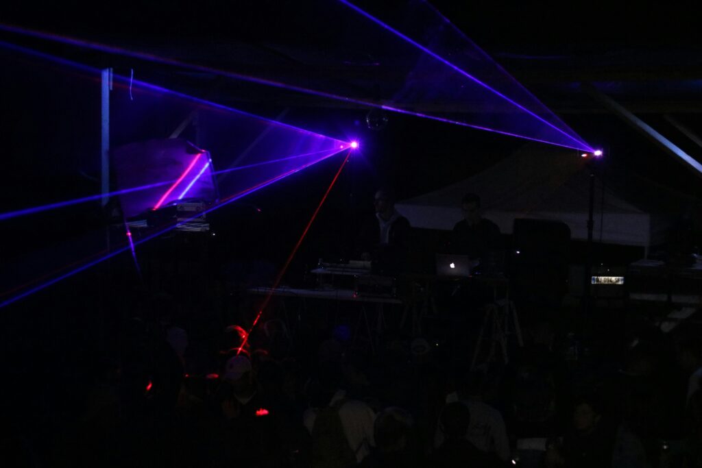 three blue stage lights inside black room 