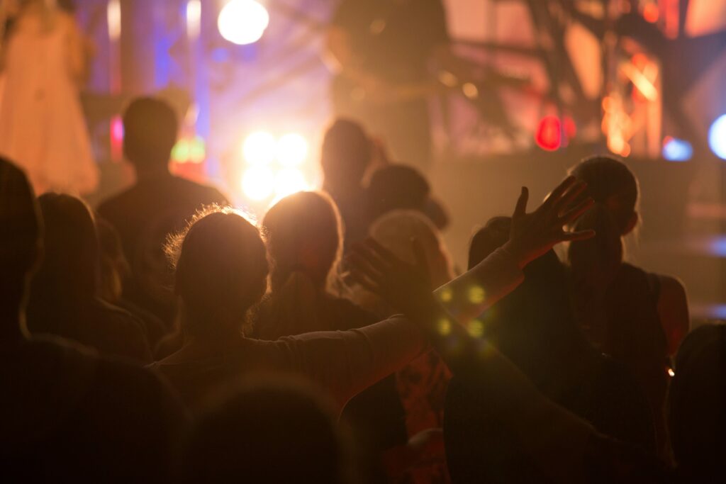 a group of people standing in front of a stage
