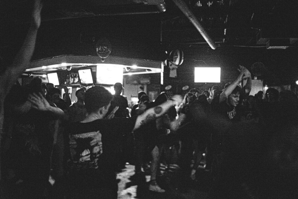 a black and white photo of a group of people dancing