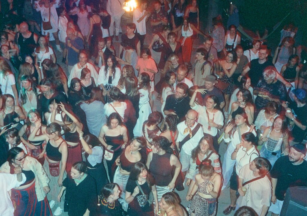 a large group of people standing around each other