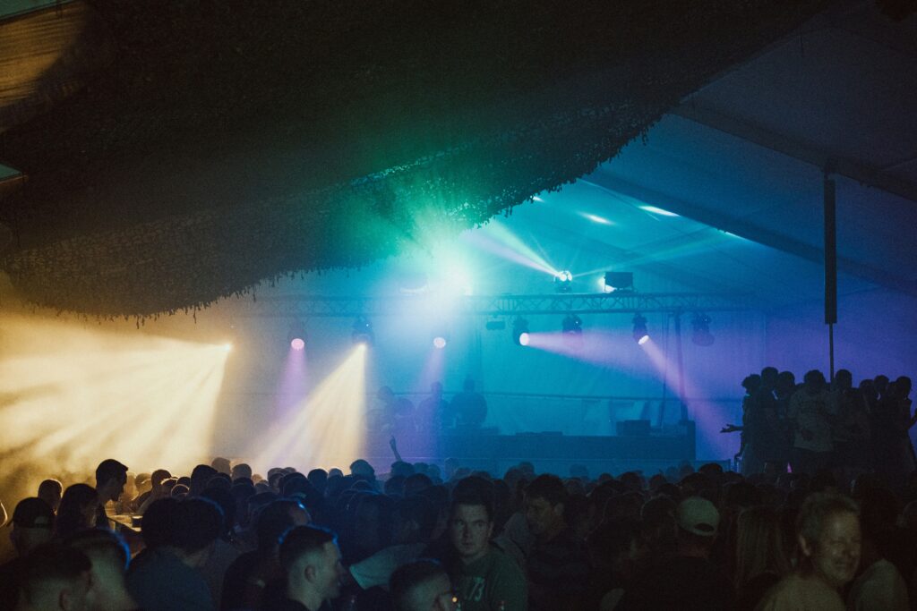 a large group of people standing in front of a stage