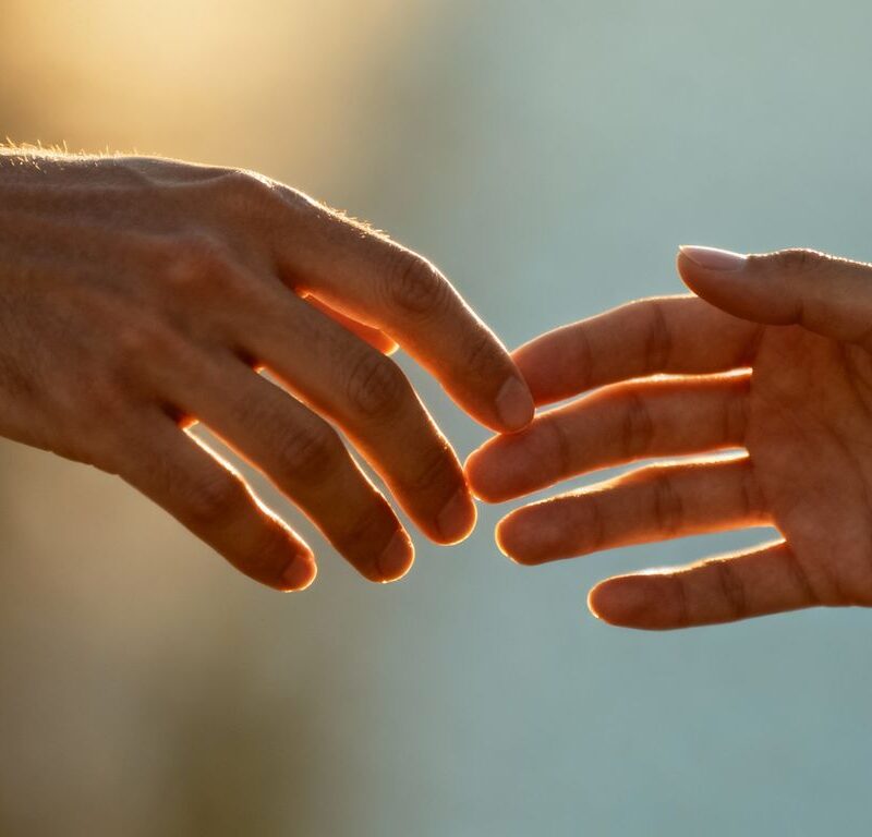 Two hands touching intimately, symbolizing connection and intimacy.