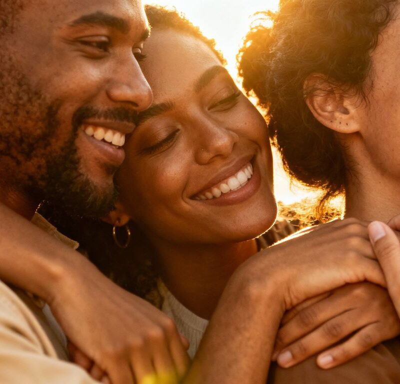 Diverse group in intimate embrace, conveying polyamorous commitment.