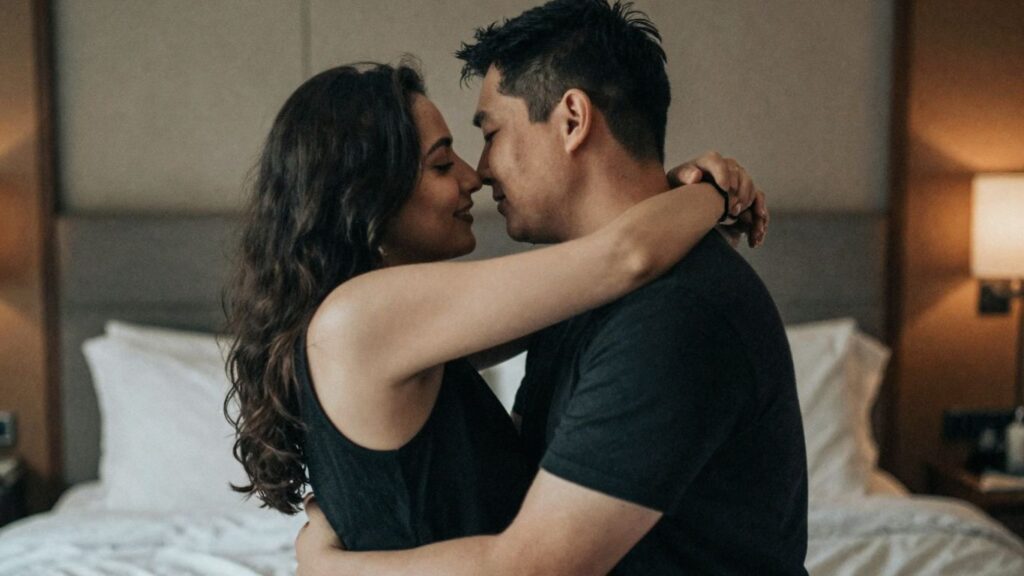 Couple embracing intimately in a lounge setting.