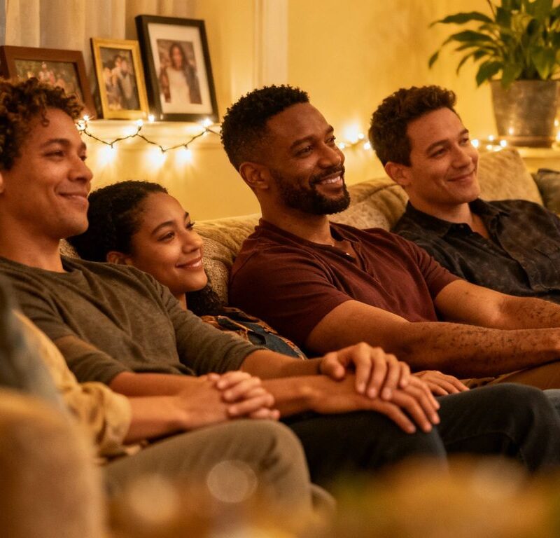 Diverse individuals connecting in a warm, intimate setting.