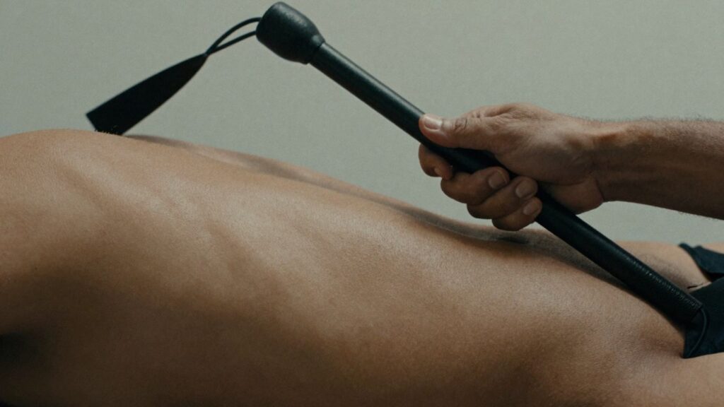 Intense BDSM flagellation scene with whip and skin.