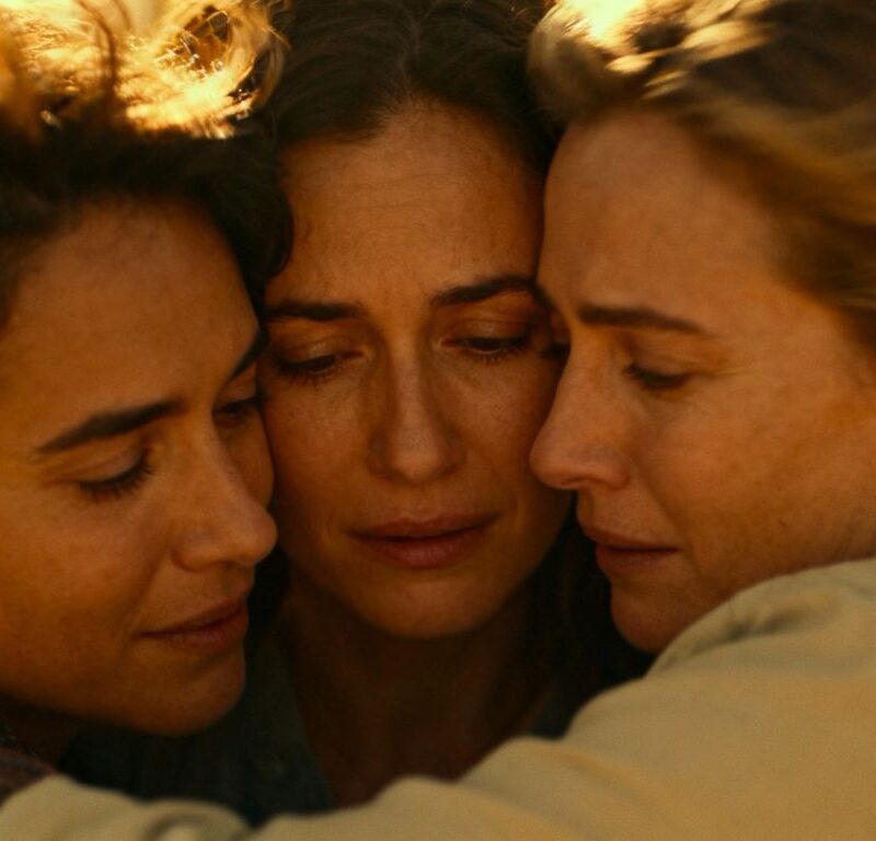 Three people in a comforting embrace after a threesome.