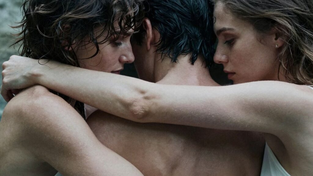 Three people in an intimate embrace, suggesting connection.