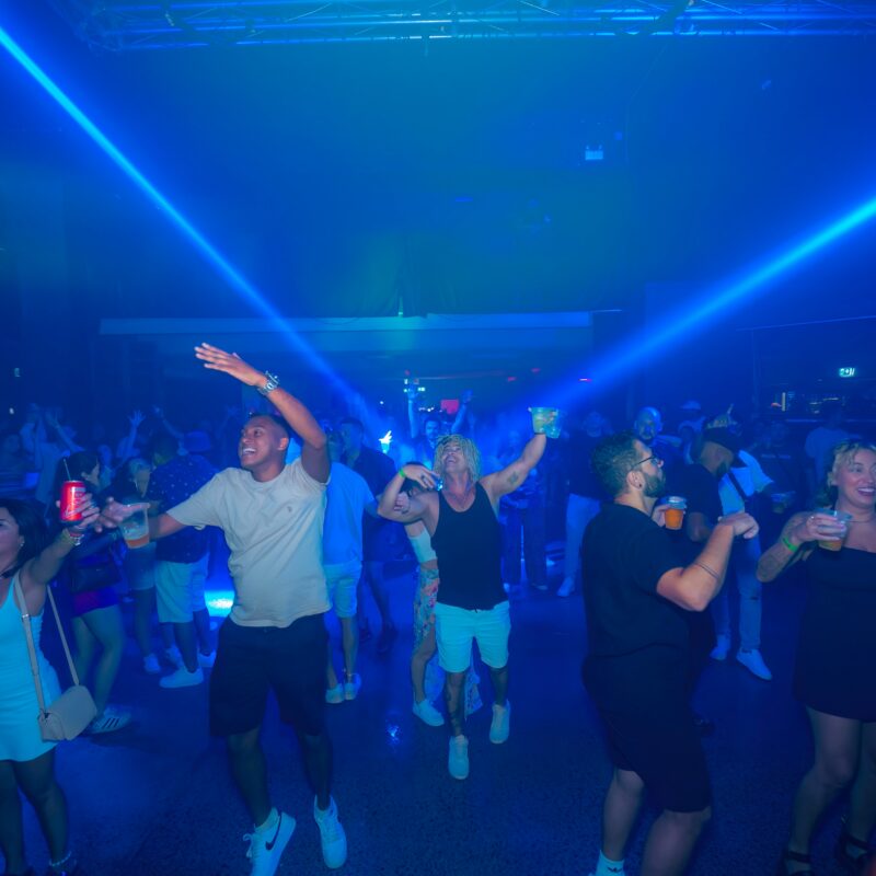 people are dancing and partying in a nightclub