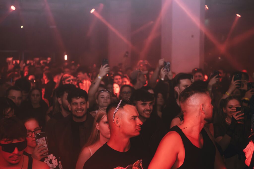 crowd enjoying a concert with red stage lights
