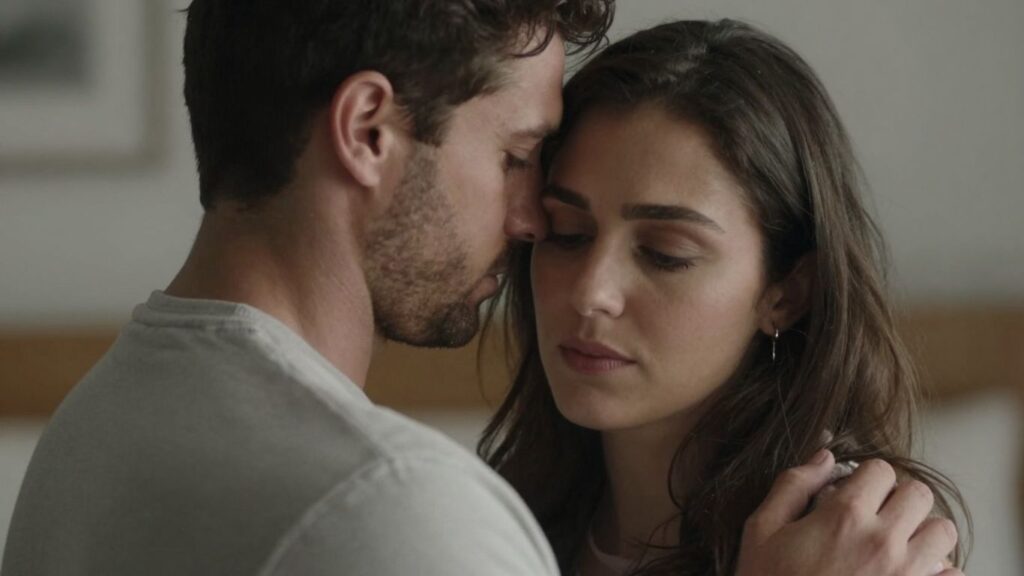 Couple embracing, conveying complex emotions of love and thought.