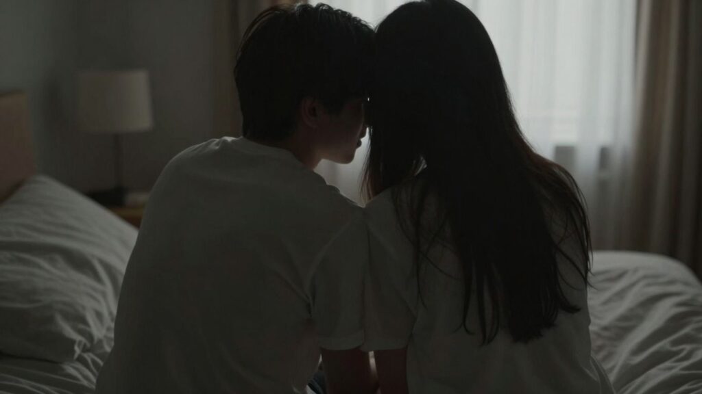 Couple in a dimly lit room, suggesting privacy.