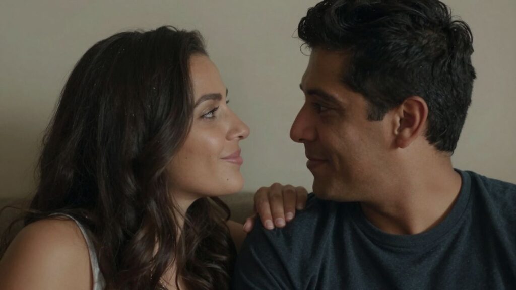 Couple in intimate attire looking at each other playfully.