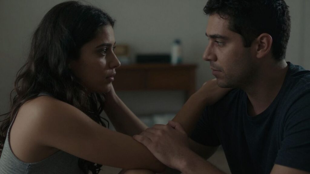 Couple in intimate setting, conveying emotional connection.