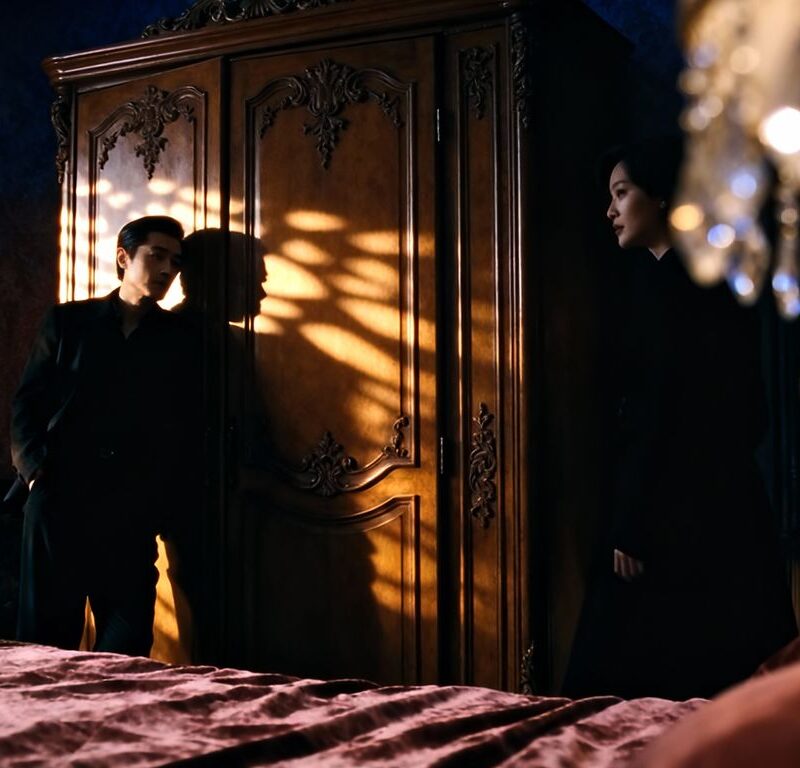 Couple near a closet in a dimly lit room.