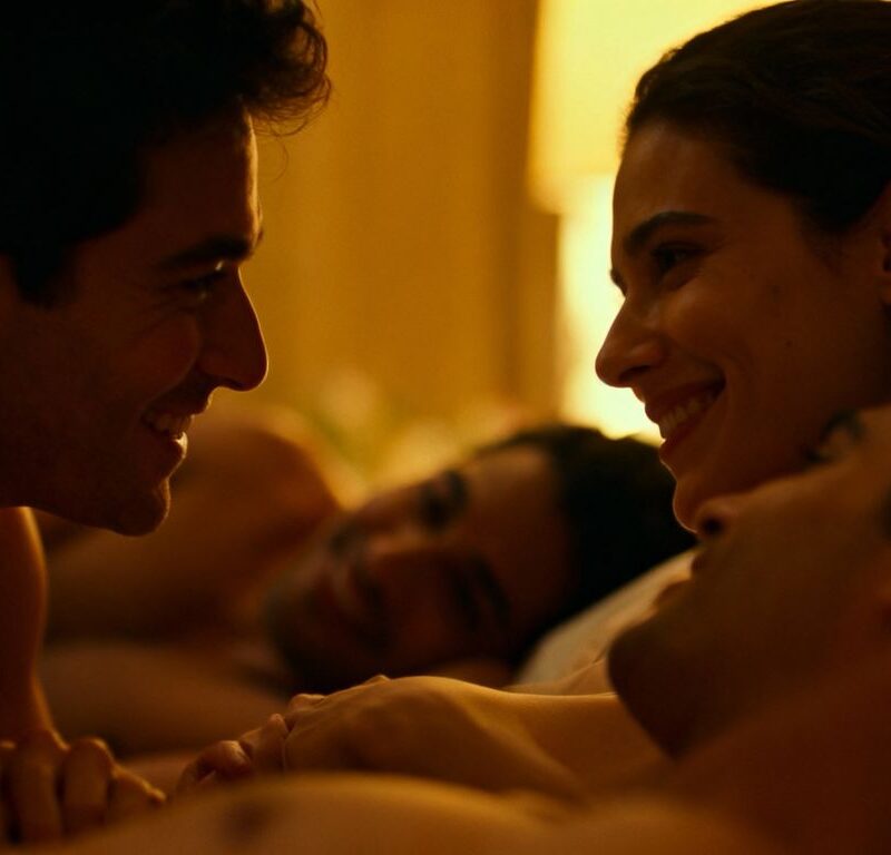 Couples engaging in consensual sexual activity in a bedroom.