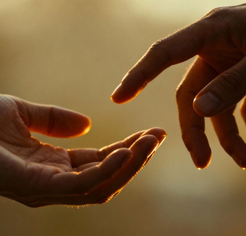 Hands gently touching, conveying emotional safety in digital intimacy.