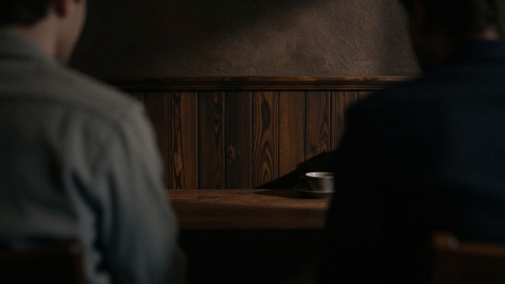 Hidden figures in a dimly lit, conservative interior.