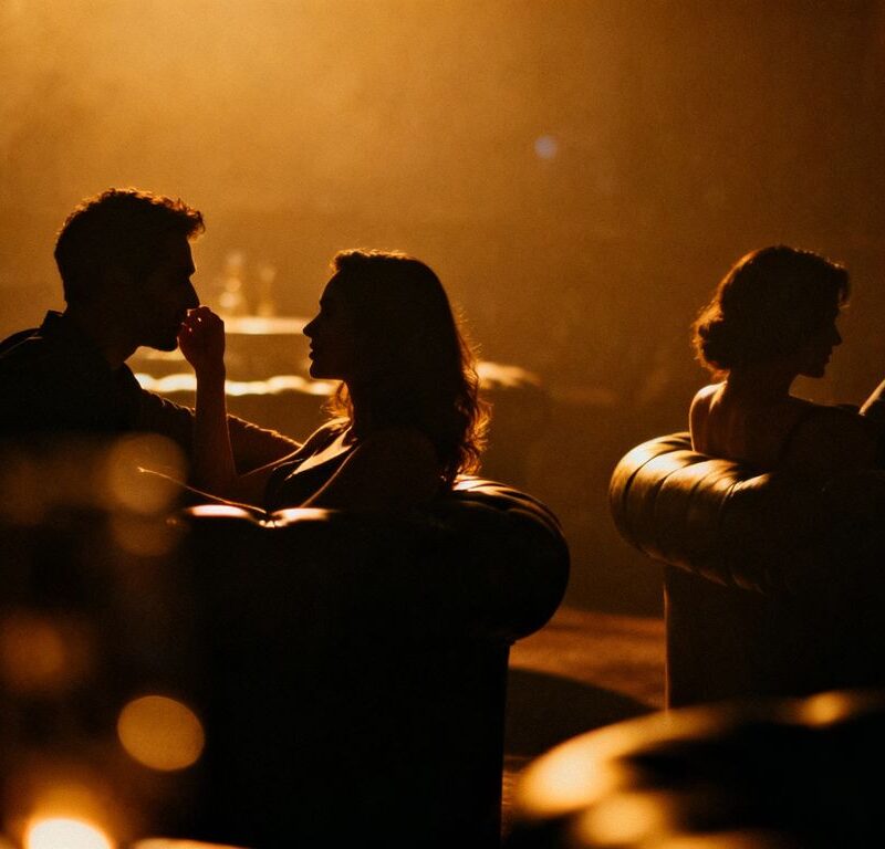 Inside a swinger club with couples mingling.