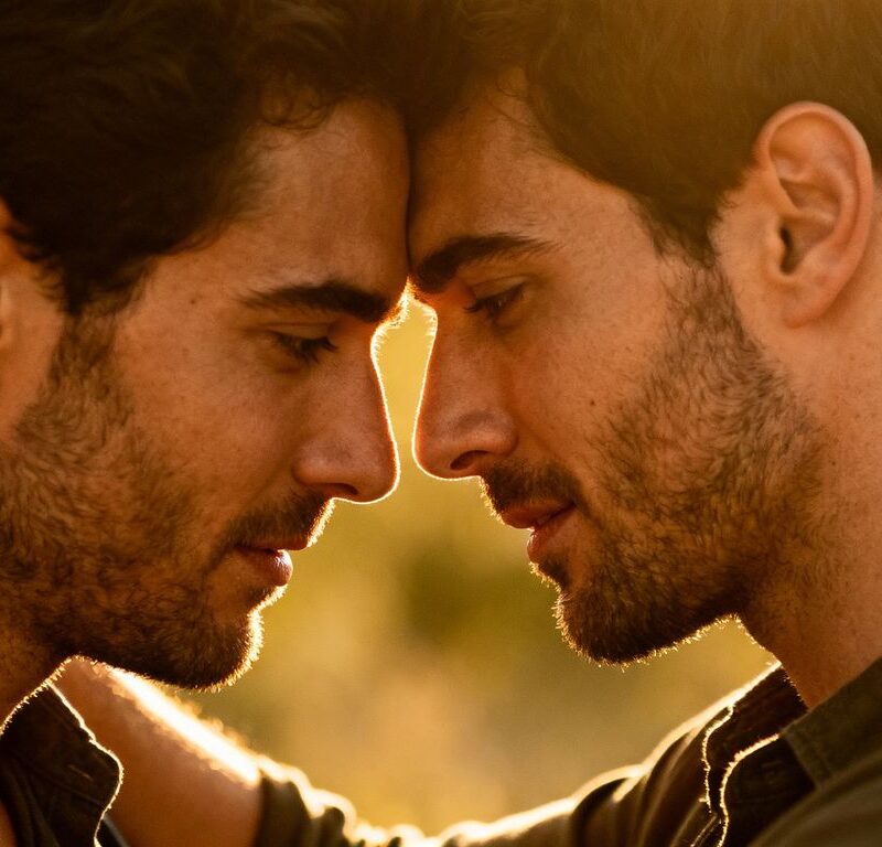 Two men embracing intimately, conveying connection and warmth.