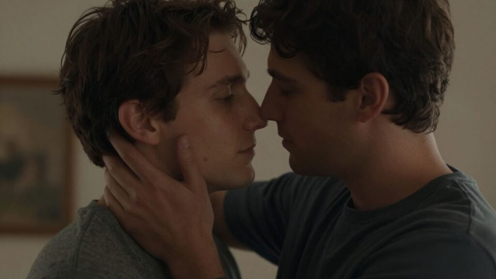 Two men embracing intimately, soft lighting, close connection.