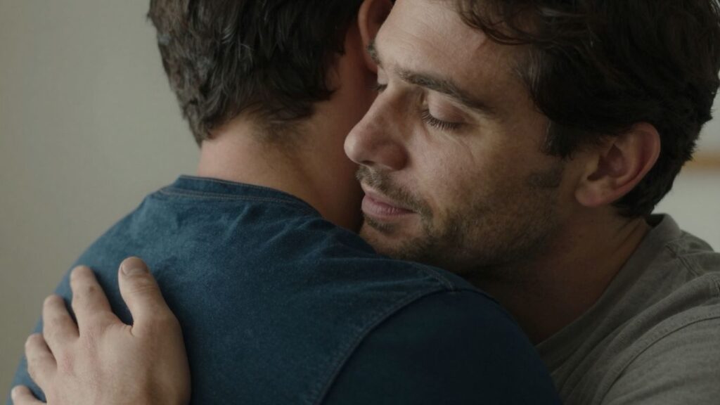 Two men embracing, showing emotional safety and connection.