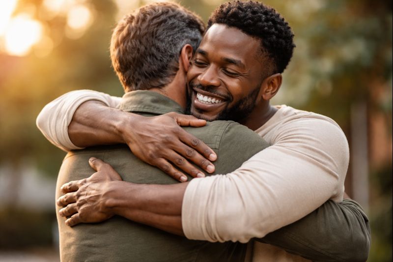 Two men embracing warmly, conveying connection and comfort.