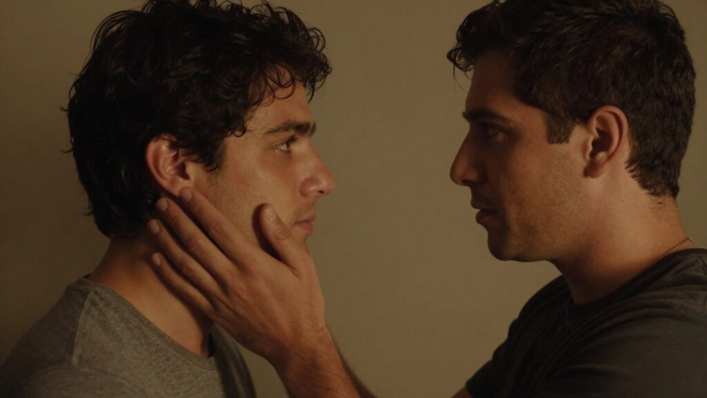 Two men exploring intimacy with gentle connection.