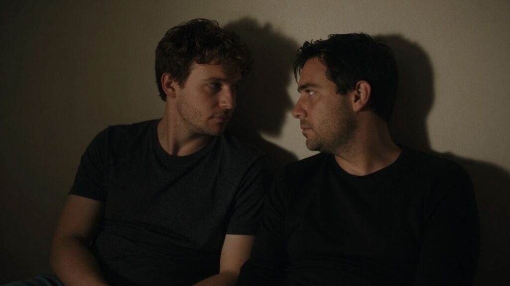 Two men in an intimate setting.