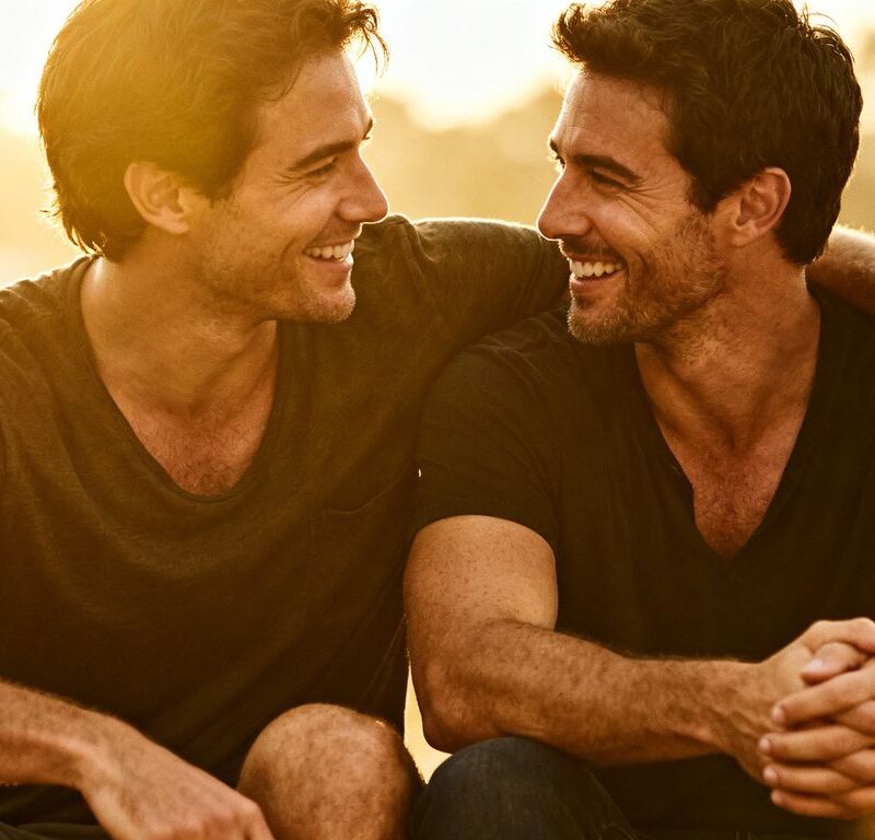 Two men sharing an intimate, comfortable moment.
