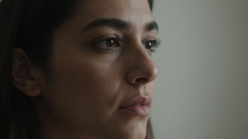 Woman's thoughtful face, conveying caution and introspection.