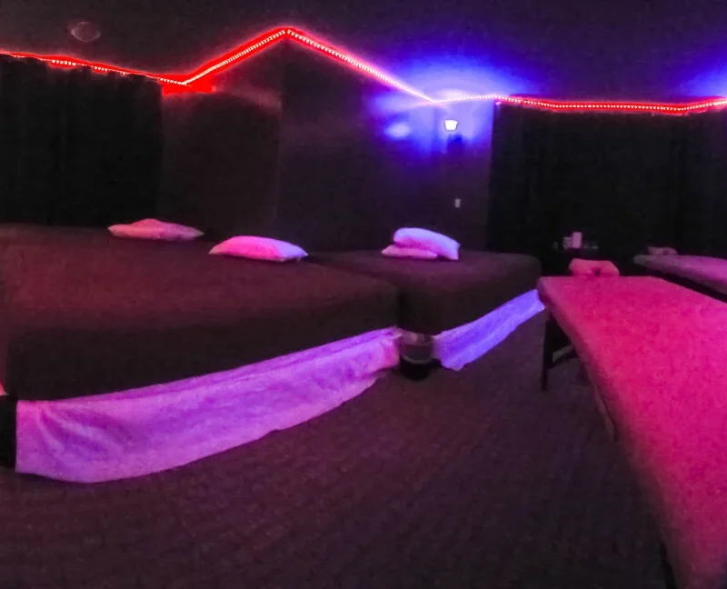 Large Open Play Rooms with Massage Tables and Open Bathroom with Hot Tub and Showers