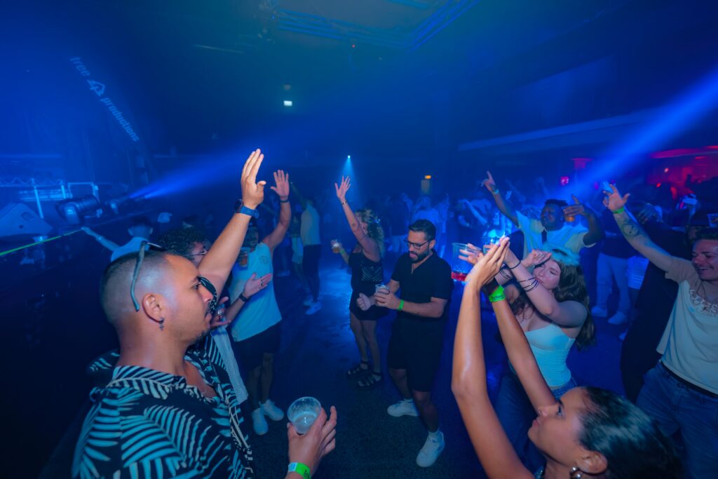 people are dancing and partying in a nightclub