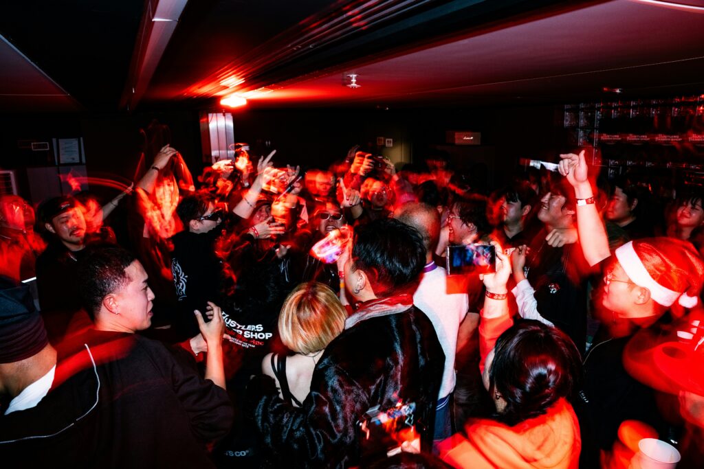 crowd dancing at a red lit concert