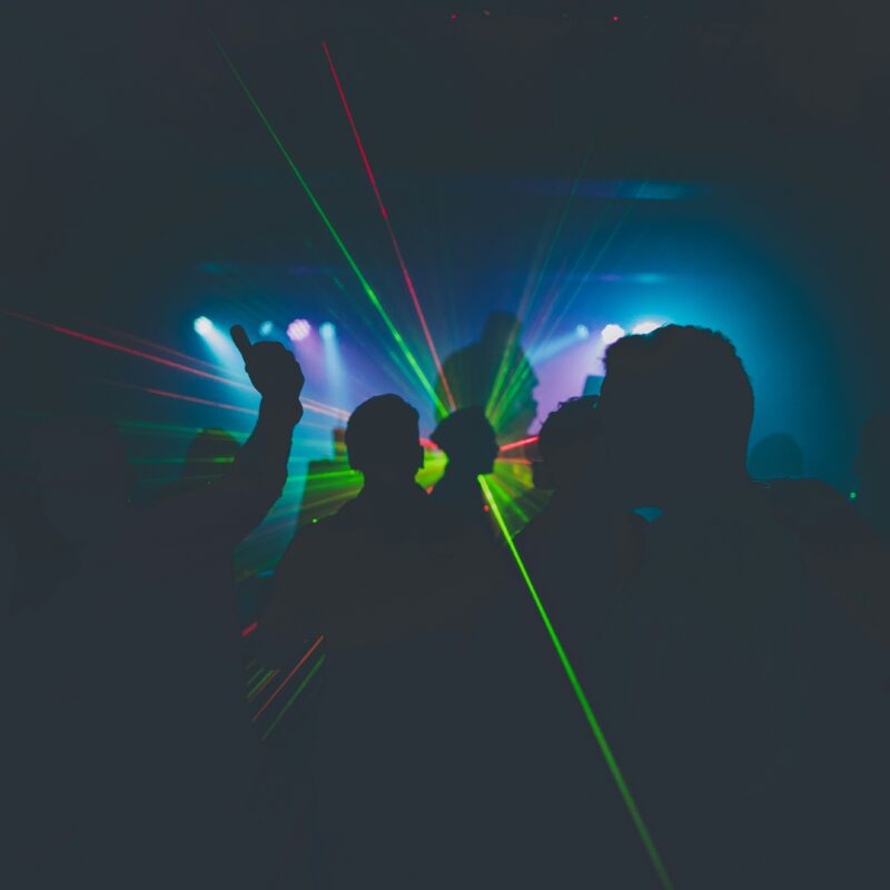 silhouette of man holding blue light